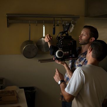 videographer and AC operating a Red camera