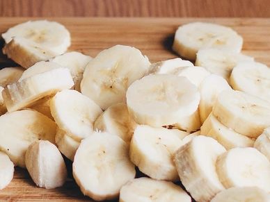 Sliced bananas arranged on a wooden surface.