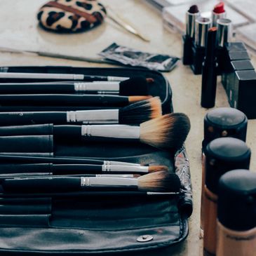 Makeup brushes and cosmetics neatly arranged on a table.