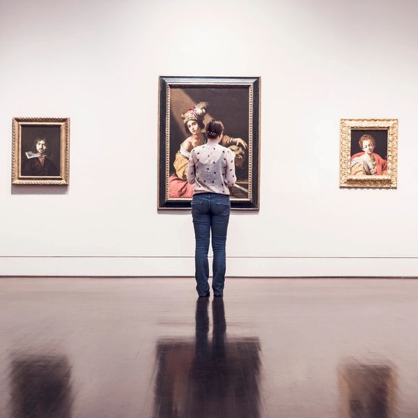 Woman standing and looking at art.