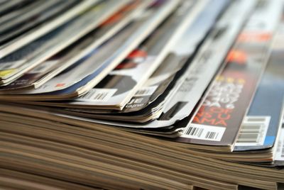 A stock photo of various journals laid out on a wooden table 