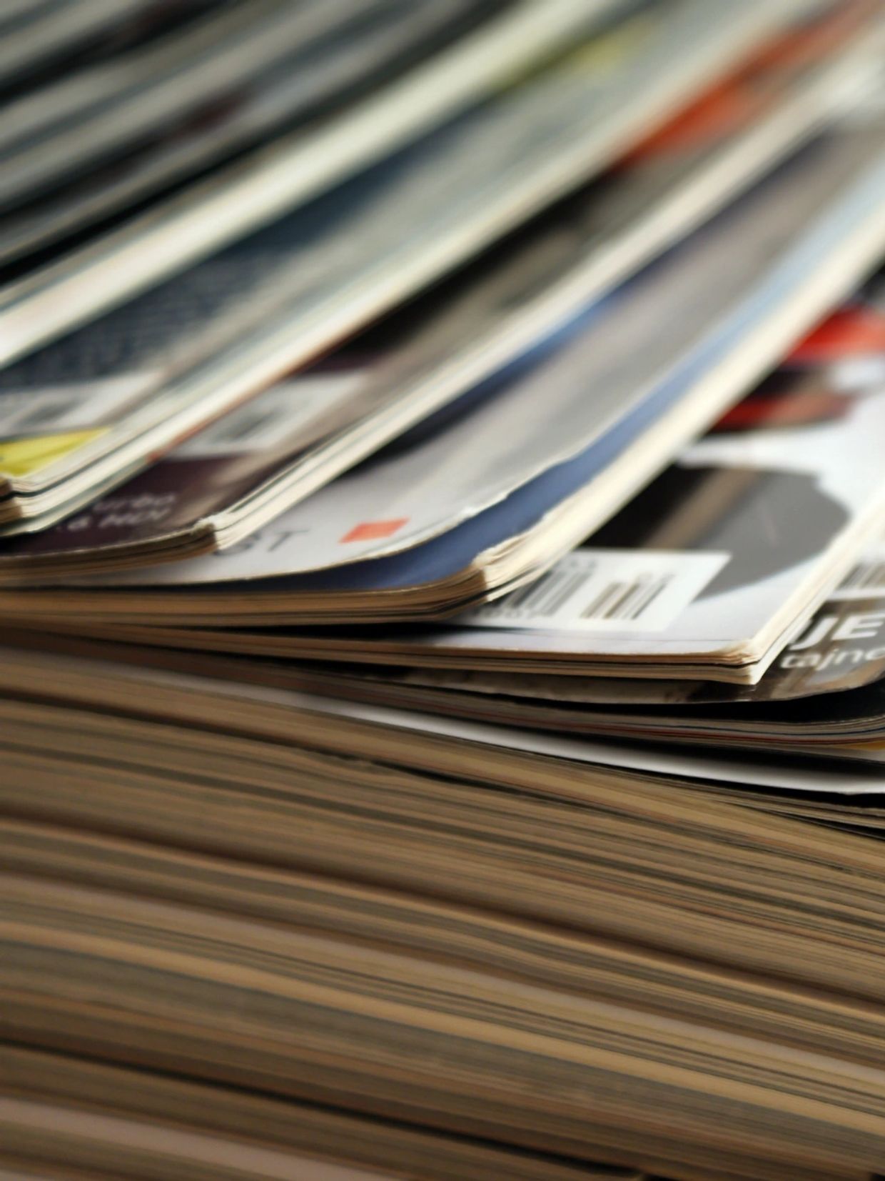 Close-up of a stack of magazines with visible barcodes.