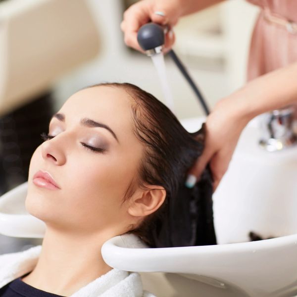 Woman relaxing while getting her hair washed at a salon.