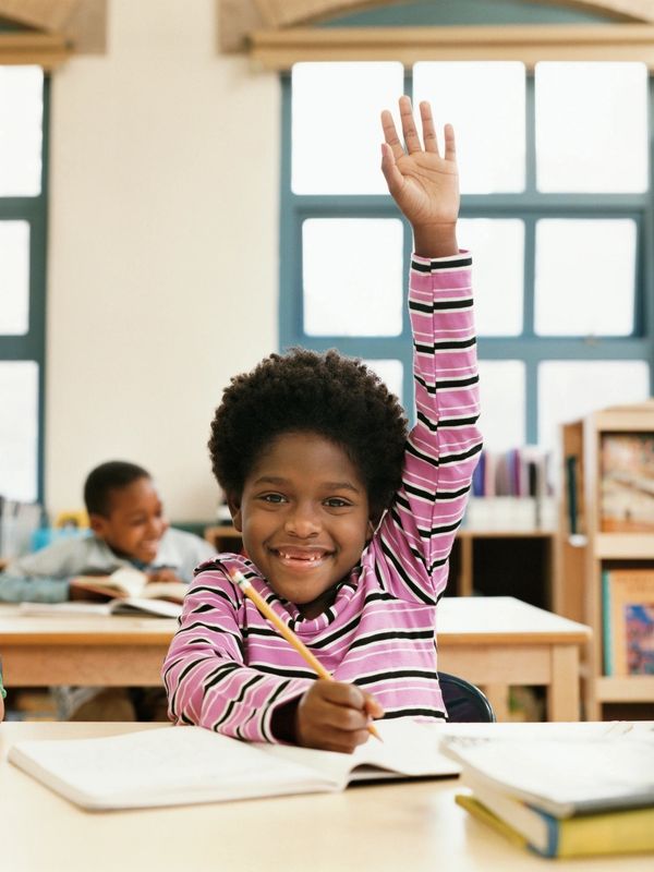 Black school-aged girl in the classroom that is excelling socially &  academically!