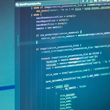 Code displayed on a computer screen with blue lighting.