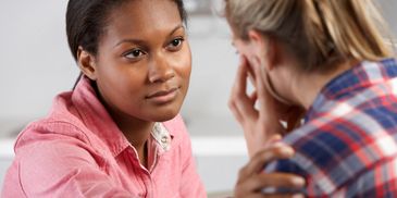 A woman is talking to another person