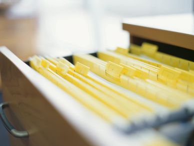 Open drawer filled with organized yellow file folders.
