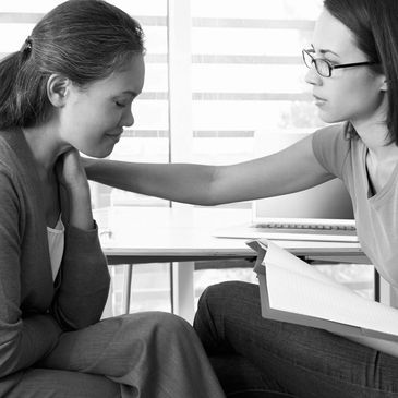 A woman being counseled by another woman