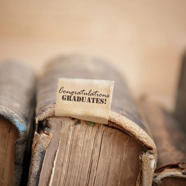 Old book with a "Congratulations Graduates!" note.
