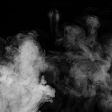 White smoke swirling against a black background.