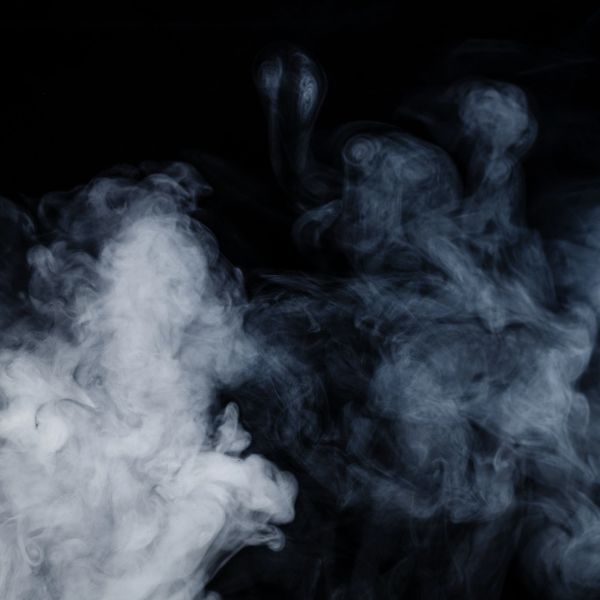 White smoke swirling against a black background.
