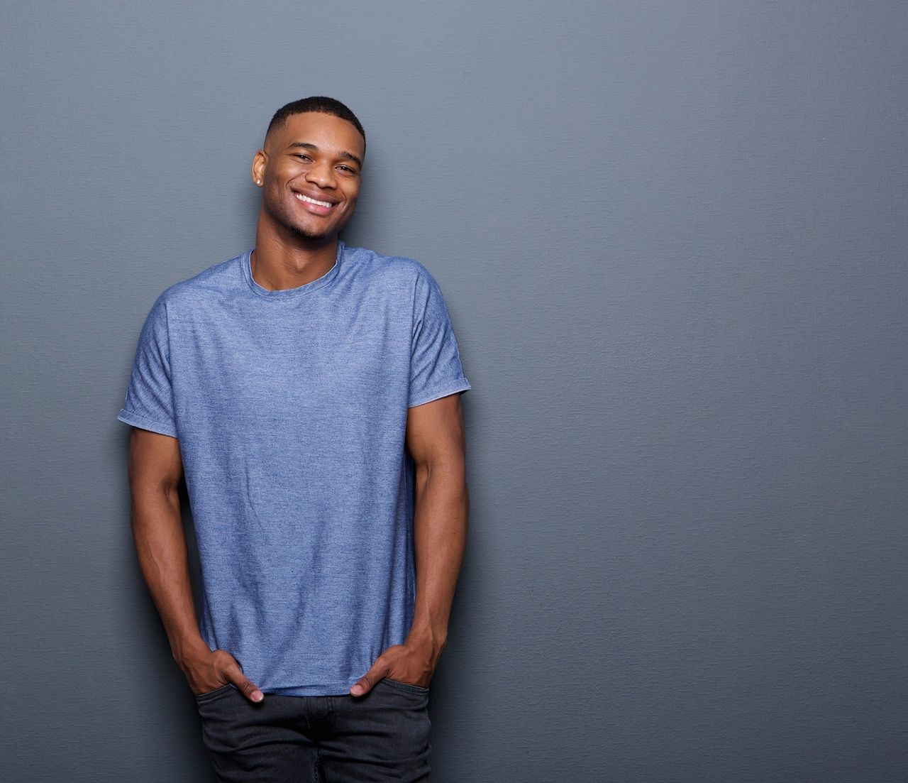 Smiling young man in blue t-shirt