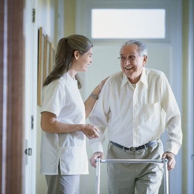 a woman taking care of an elderly man.