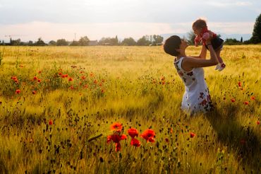 mom and baby in field of poppies