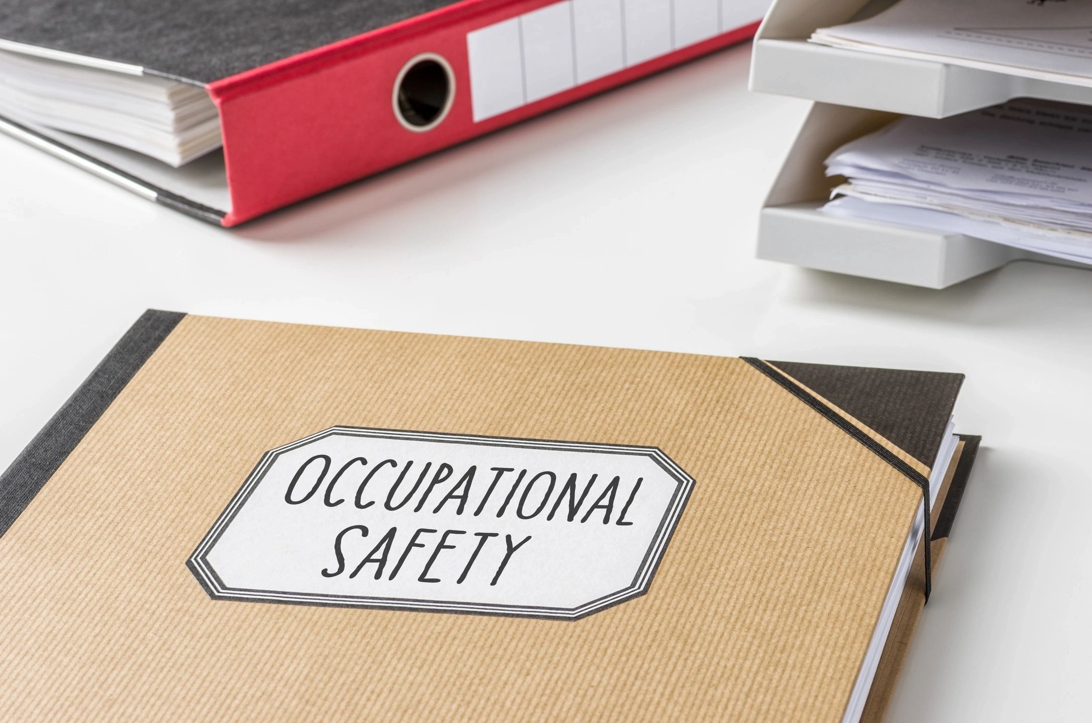 Folder labeled Occupational Safety with office files and papers.