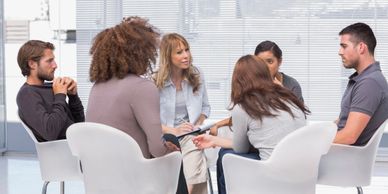 A picture of six people sitting in a circle