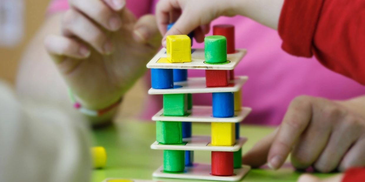 A boy playing with the building game for kids.