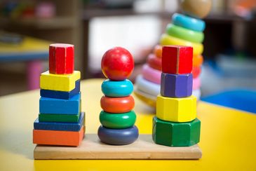 Colorful wooden stacking toys on a table.