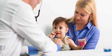 a doctor checking a baby for any diseases with his stethoscope 