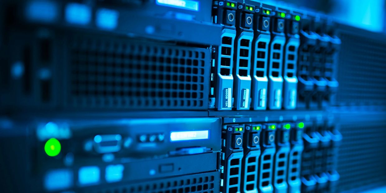 Close-up of a blue-lit server rack with multiple hard drives.