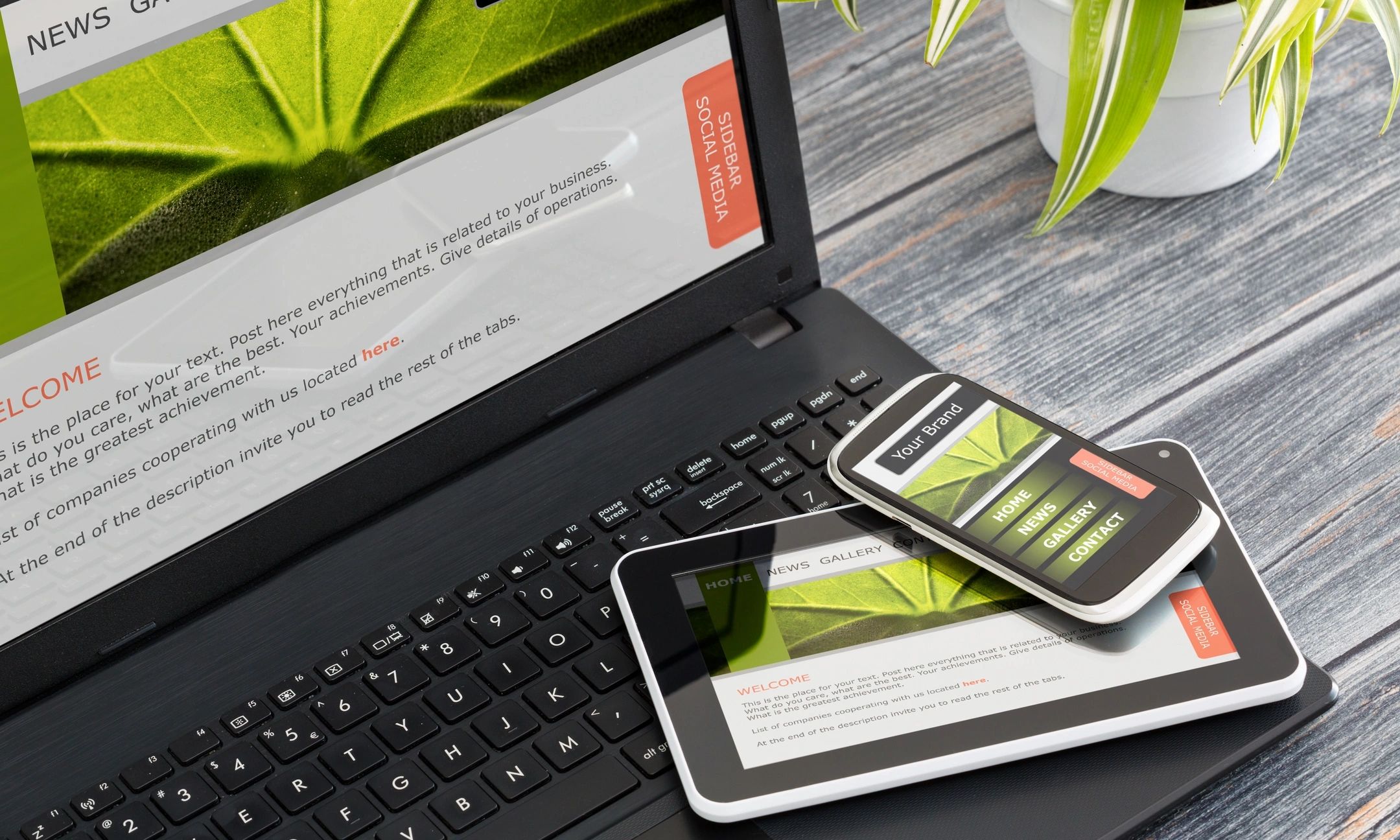 Website displayed on laptop, tablet, and smartphone on a wooden desk with a plant.
