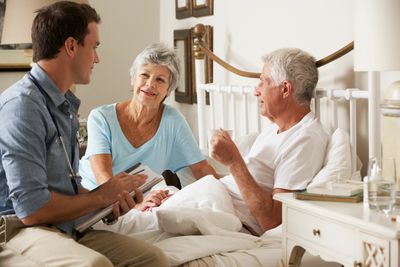 Intake for home health in home care discussing daily care options while husband has coffee