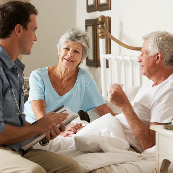 A carer checking up on two patients in their home