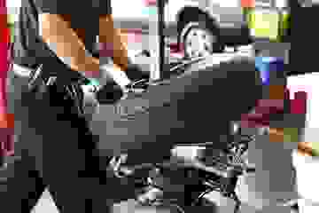 A tyre fitter using a tyre changer machine.