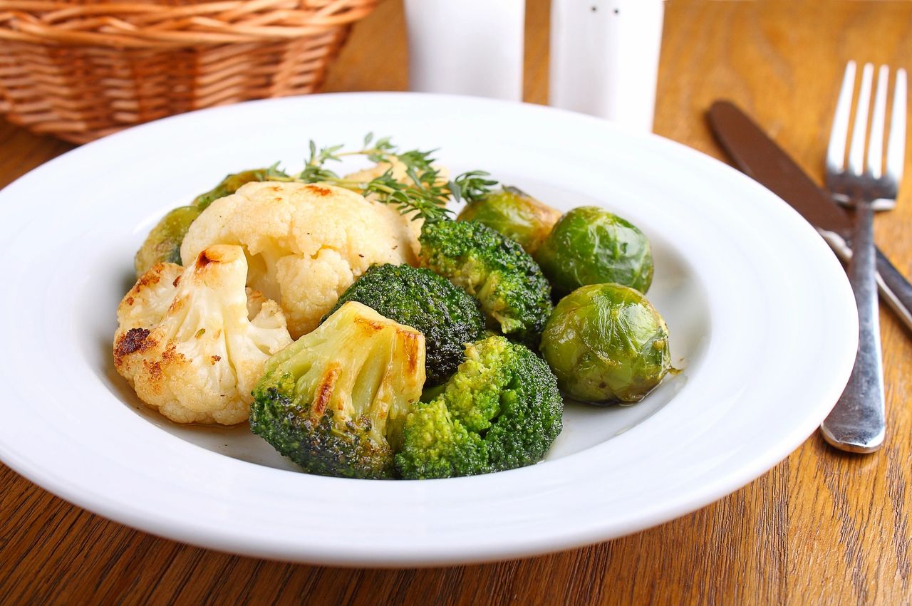 Plate of broccoli, sprouts, cauliflower and a knife and fork
