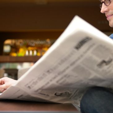 A person reading a newspaper 