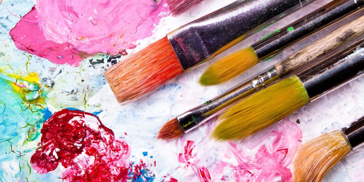 Close-up of paintbrushes and colorful paint.