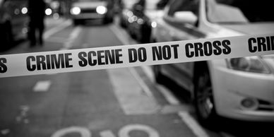 Crime scene tape blocking a street.