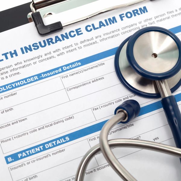 Health insurance claim form with a stethoscope on a clipboard.
