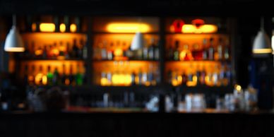 Blurred background of a bar with colorful lights.