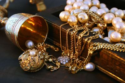 treasure trove, chest of jewels, gold, pearls, bronze cup, necklaces, valuables, spilling abundance