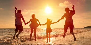 family playing at the beach