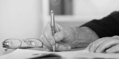 a person writing with a pen