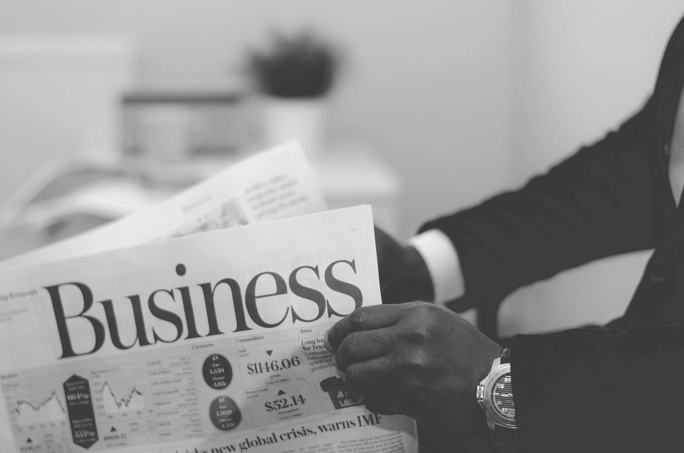 Person reading a business newspaper.