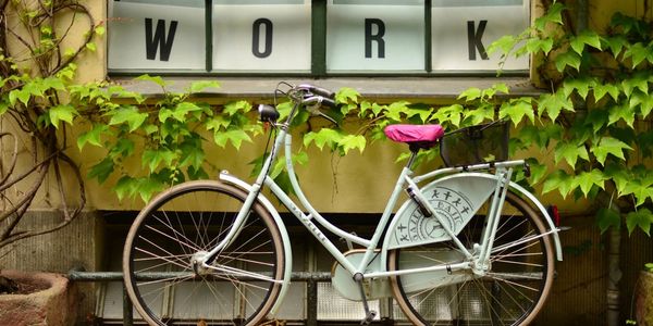 image of a bicycle parked below the words Work 