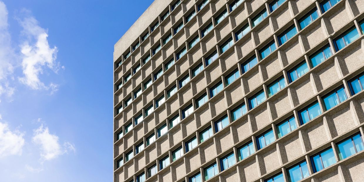 A high-rise apartment building or hotel with multiple rooms and windows