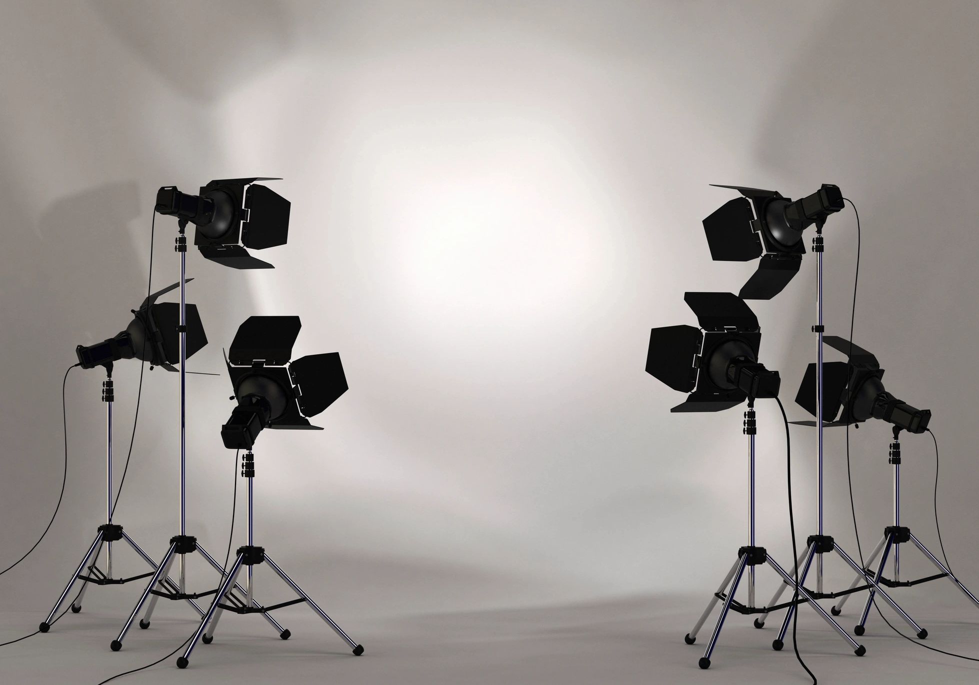 Six professional studio lights with barn doors arranged in two groups against a plain backdrop.