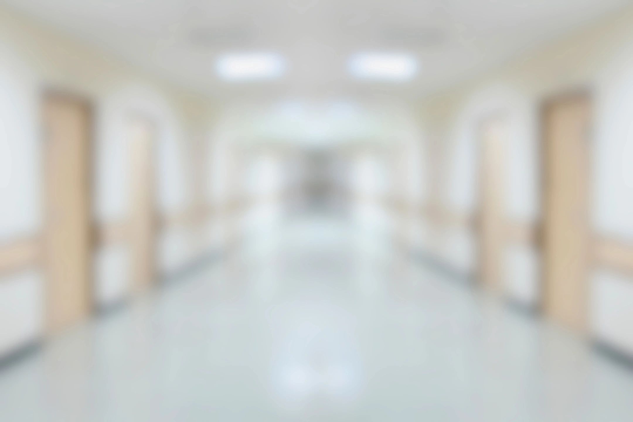 Bright, modern corridor with multiple doors and soft lighting.
