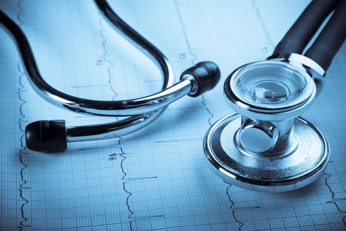 Medical website banner with contact details visible. Stethoscope and chart in background.