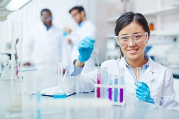 A millennial Asian girl dressed up like a lab assistant.  Ha!  A little stock photo humor.