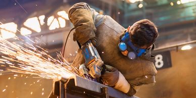 An employee used a hand grinder and flap discs while blending the metal beam.