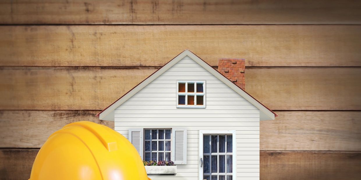 a hard hat beside a model house