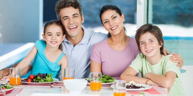 Family smiling and eating