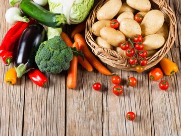 vegetables in a basket on wooden floor
