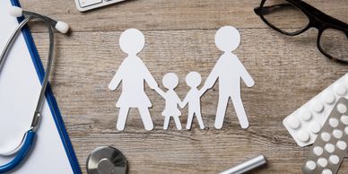Paper cutout of a family of four on the table 