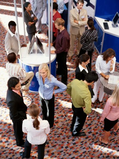 People networking and discussing at a professional event or conference.